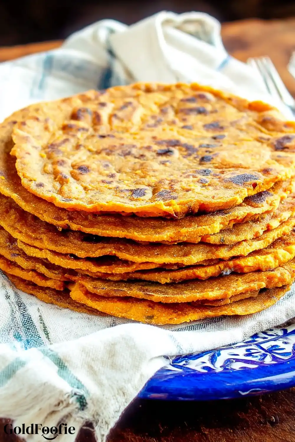 Easy 3-Ingredient Sweet Potato Tortillas 5 Stack of golden sweet potato tortillas on a white and blue towel