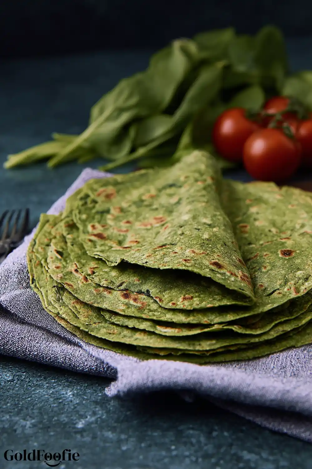 Easy Grain-Free Spinach Tortillas 5 Close-up of grain-free spinach tortillas stacked on a cloth napkin