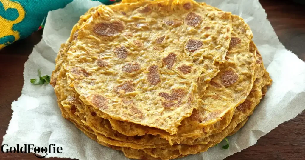 Stack of golden chickpea flour tortillas on parchment paper