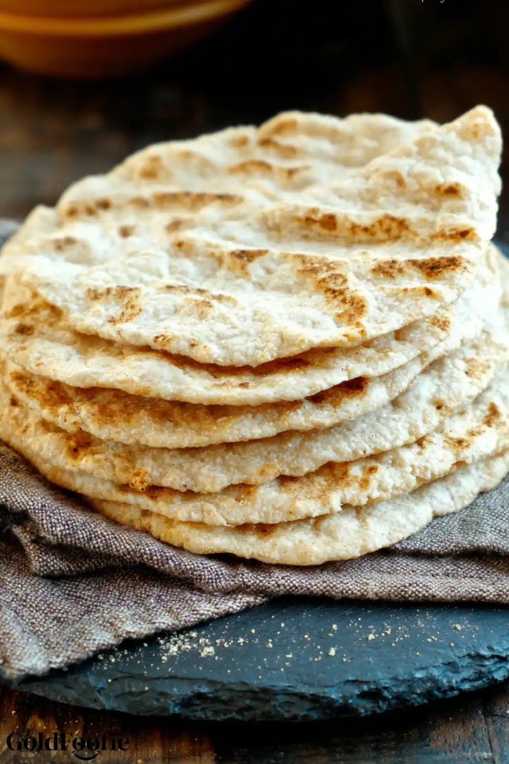 2 Ingredient Coconut Flour Tortillas Recipe 5 Stack of homemade coconut flour tortillas on a rustic black slate