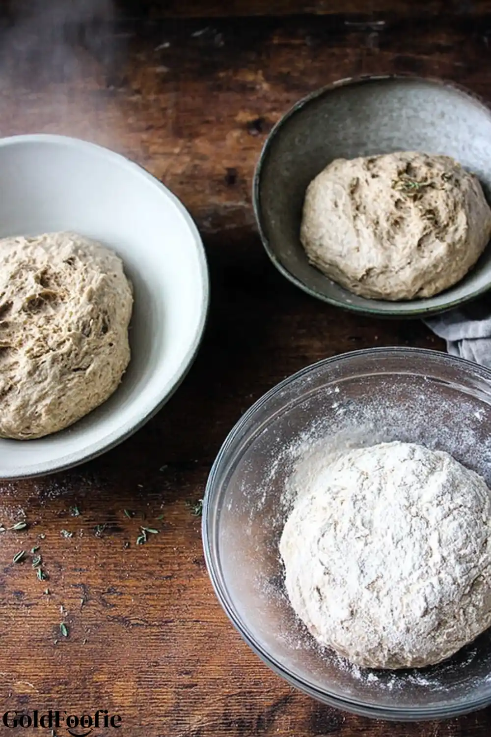 Dough Rising for Bread Bread dough rising in mixing bowls on wooden surface