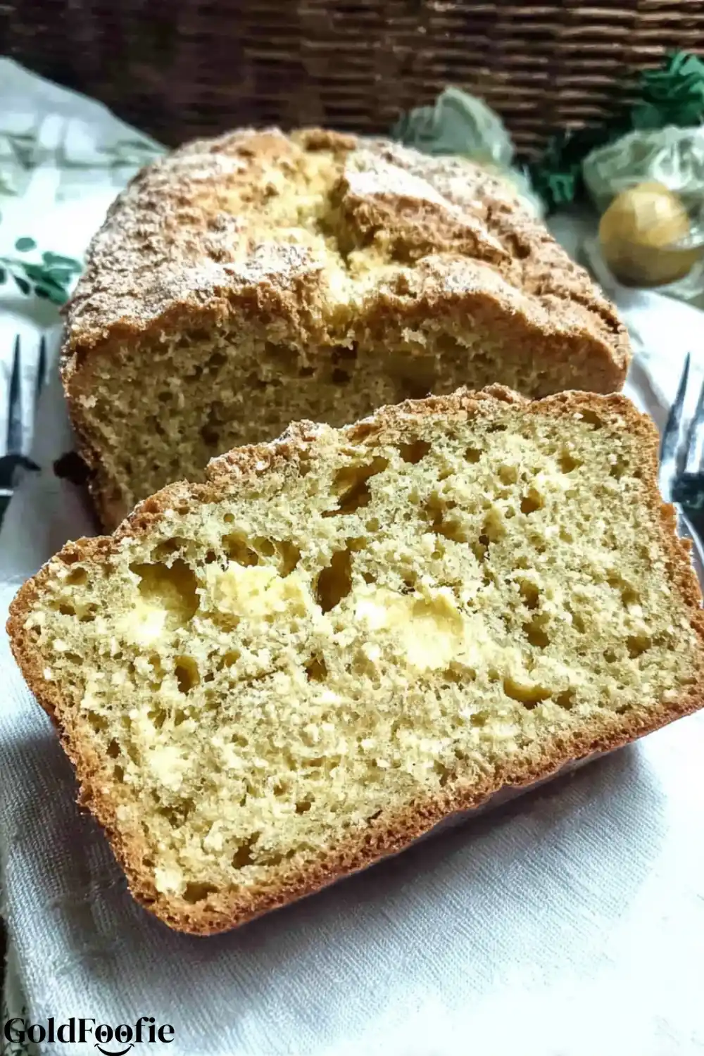 Savory Lupin Bread Loaf A slice of cheesy lupin flour bread in front of the loaf on a white cloth.
