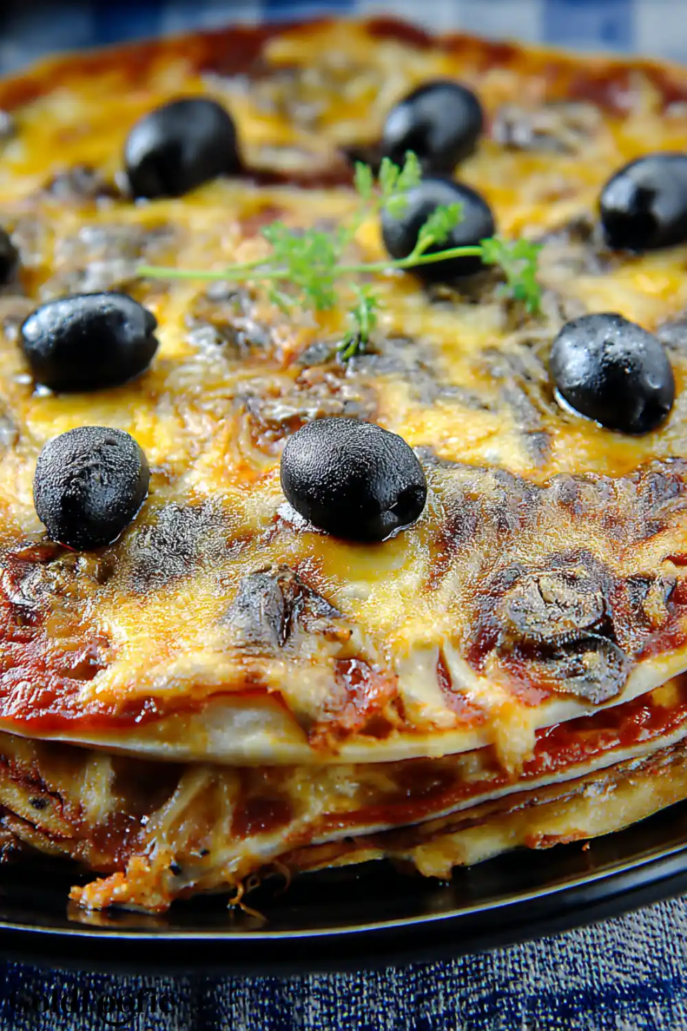Crispy Pizza with Low Carb Tortilla Recipe 5 Multi-layered pizza made with low carb tortillas and topped with black olives and cheese