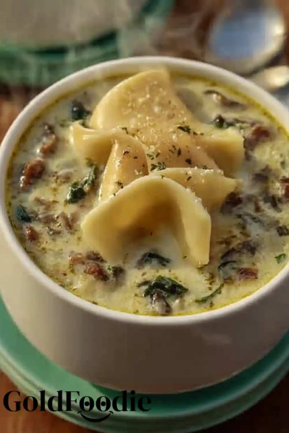 Classic Alfredo Lasagna Soup Alfredo lasagna soup with pasta and spinach on a green plate