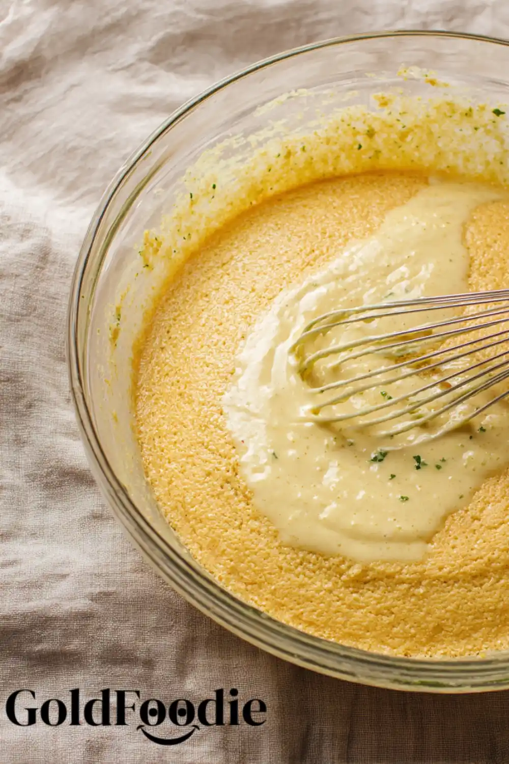 Cornbread Batter in Progress Cornbread batter in bowl with whisk.