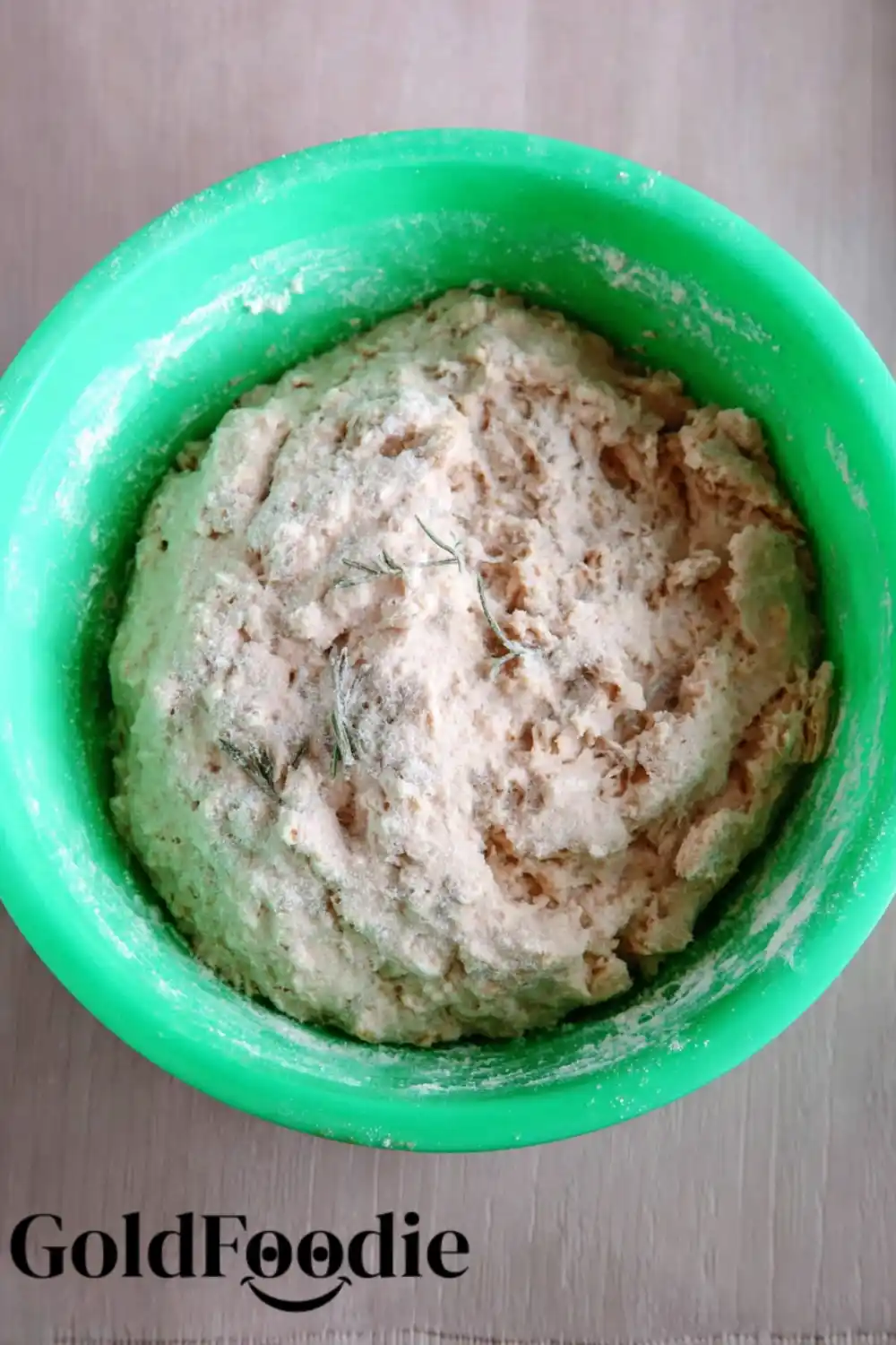 Mixing the Dough Oatmeal bread dough mixed in a green bowl.