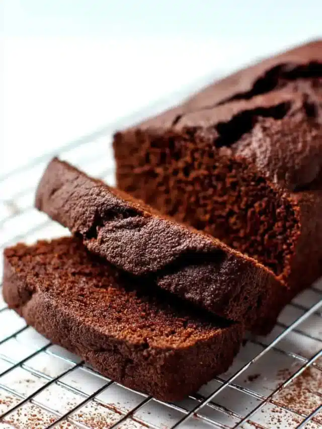Sliced chocolate banana bread on cooling rack.