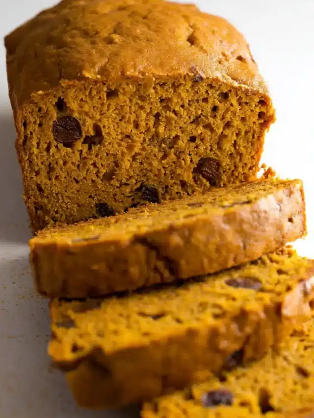 Thick-sliced pumpkin banana bread loaf on a table.