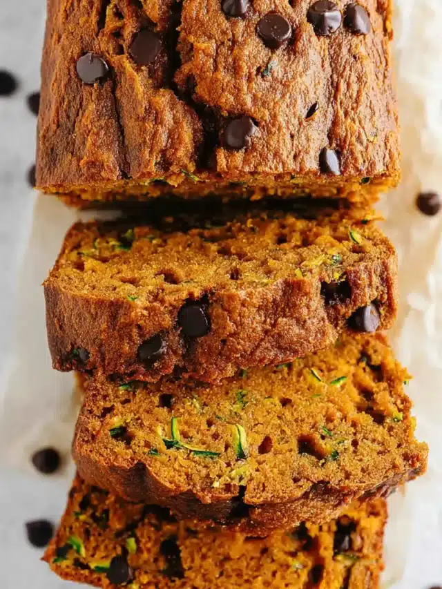 Close-up of sliced pumpkin zucchini bread showing moist texture.