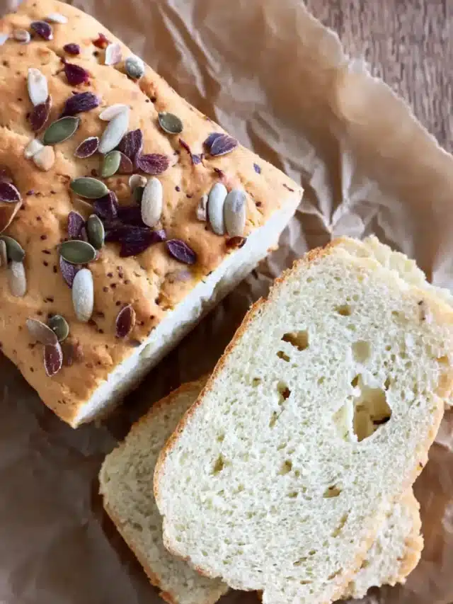 Vegan almond bread topped with sunflower and pumpkin seeds