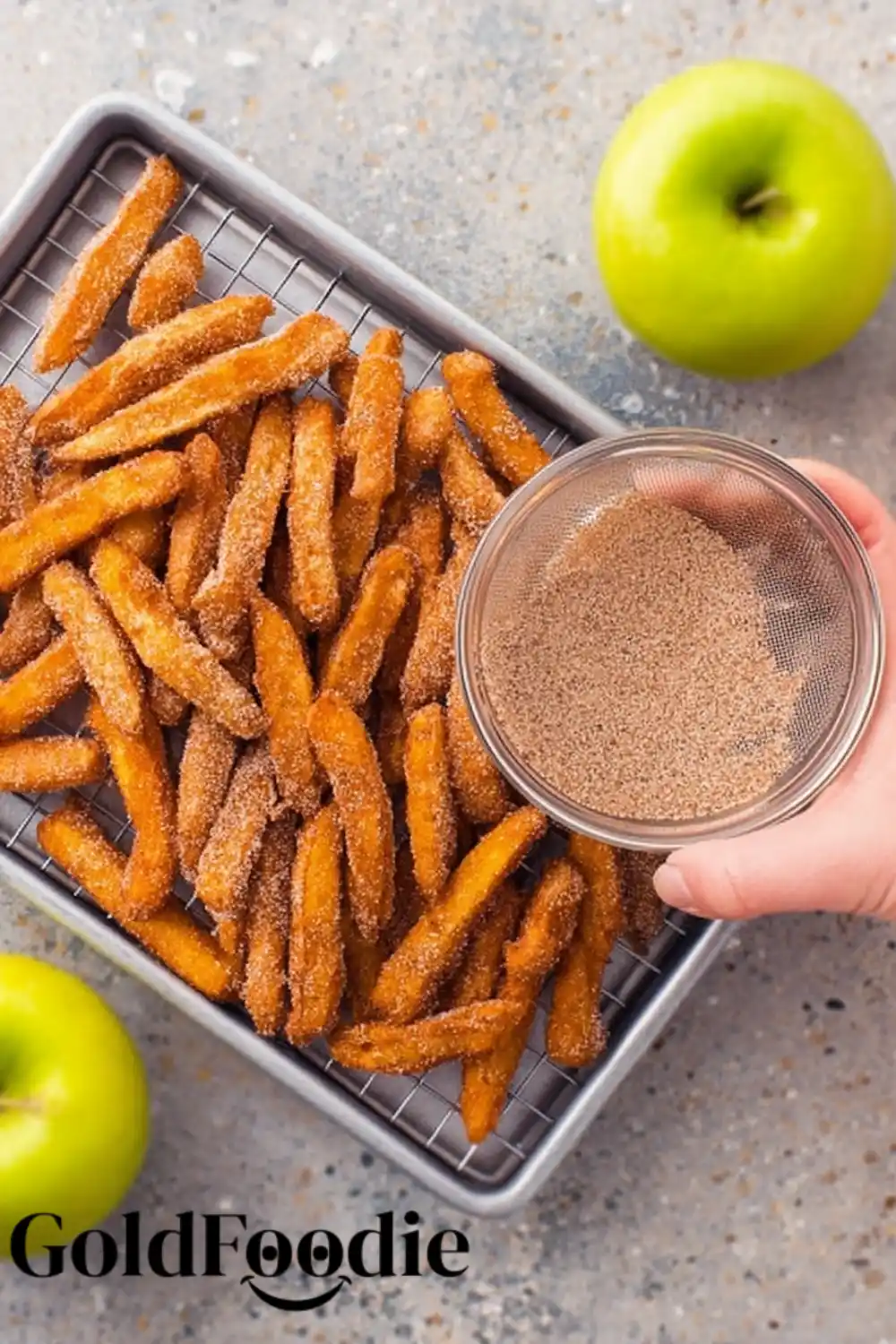Dusting Hot Apple Fries with Cinnamon Sugar Dusting Hot Apple Fries with Cinnamon Sugar