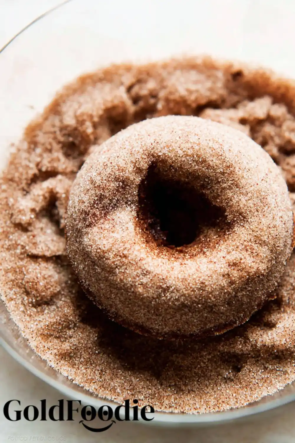 coating-donut-in-cinnamon-sugar coating-donut-in-cinnamon-sugar