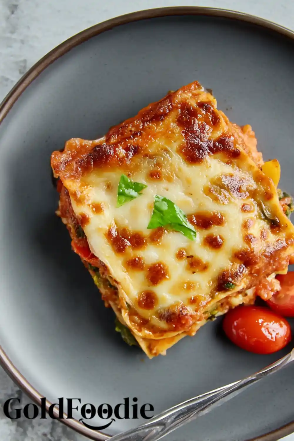 Single Serving of Veggie Lasagna on a Grey Plate Single Serving of Loaded Veggie Lasagna