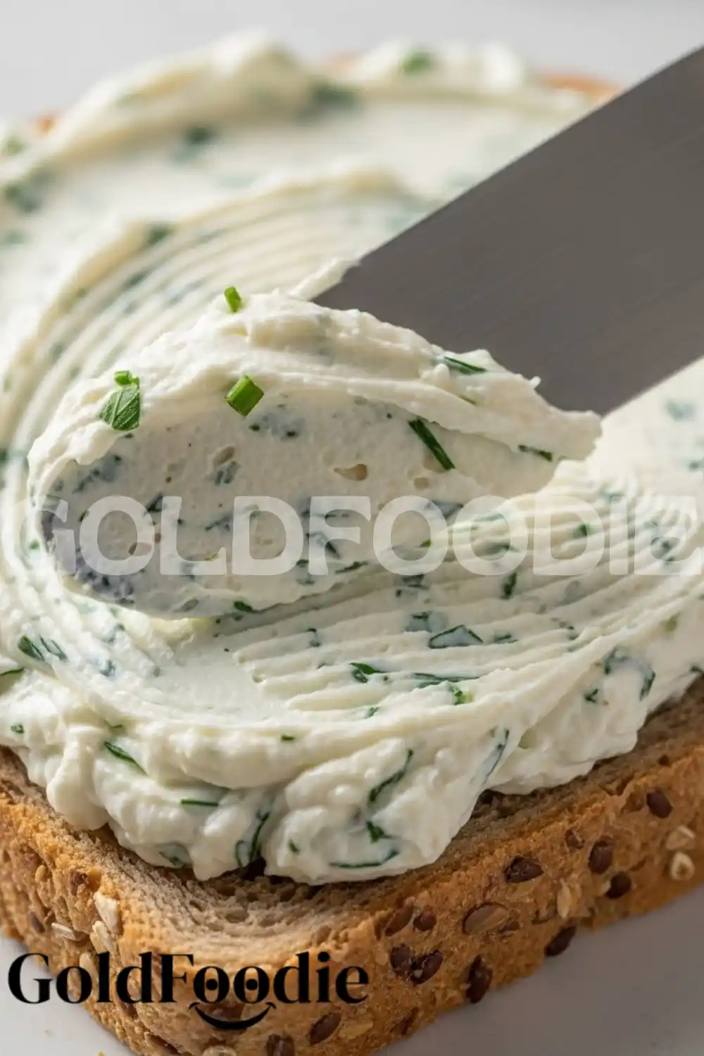 Spreading Herbed Cream Cheese on Whole Grain Bread