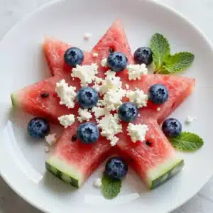 A platter of patriotic watermelon feta skewers with red, white, and blue colors.