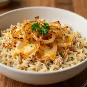 A close-up of French Onion Chicken Orzo Casserole served in a white baking dish.