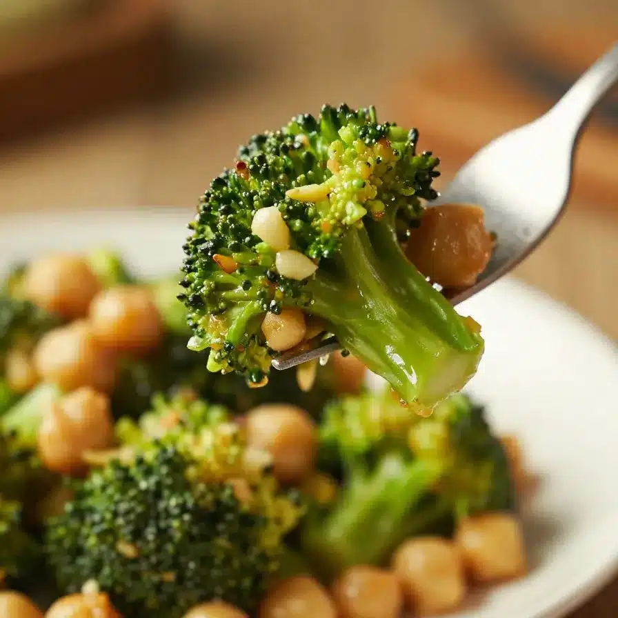 Garlic Broccoli Stir Fry with Chickpeas 5 A plate of garlic broccoli stir fry with chickpeas served on a wooden table.