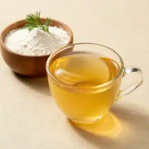 A glass of vibrant Bloom gelatin drink garnished with fresh fruits and herbs