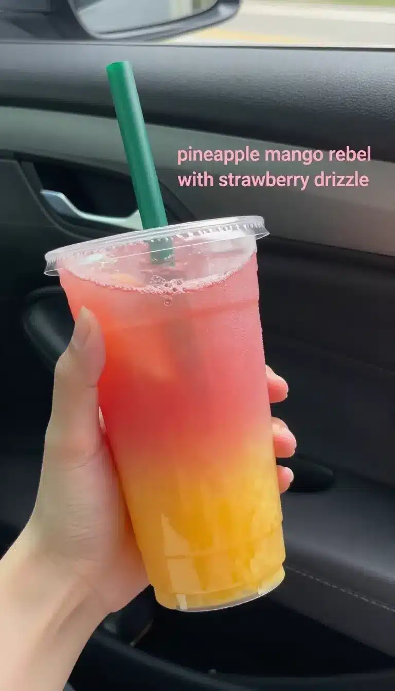 Pineapple Mango Rebel with Strawberry Drizzle 9 A refreshing Pineapple Mango Rebel drink topped with a vibrant strawberry drizzle