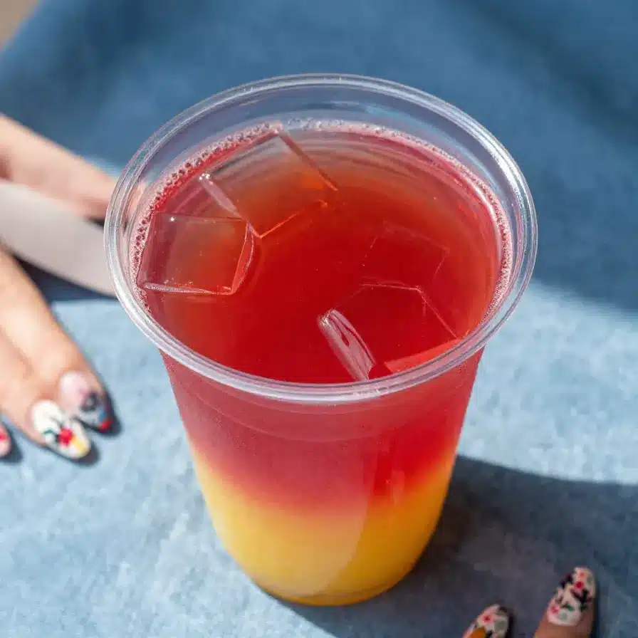 Dutch Boys Smoothie and Electric Berry Lemonade 5 A refreshing Dutch Boys Smoothie served in a glass with a colorful straw next to a vibrant Electric Berry Lemonade.
