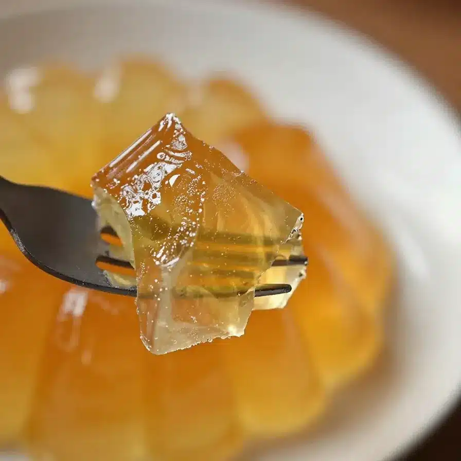 Colorful broken glass jello dessert served in a glass dish.
