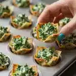 Spinach and Artichoke Wonton Cups 4 Delicious spinach and artichoke wonton cups served on a wooden platter