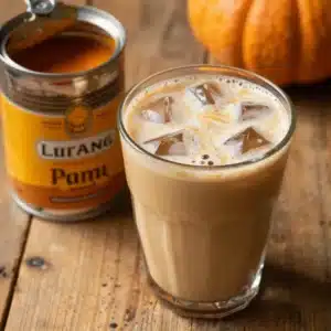 A steaming homemade pumpkin chai latte served in a ceramic mug, garnished with cinnamon sticks and star anise.