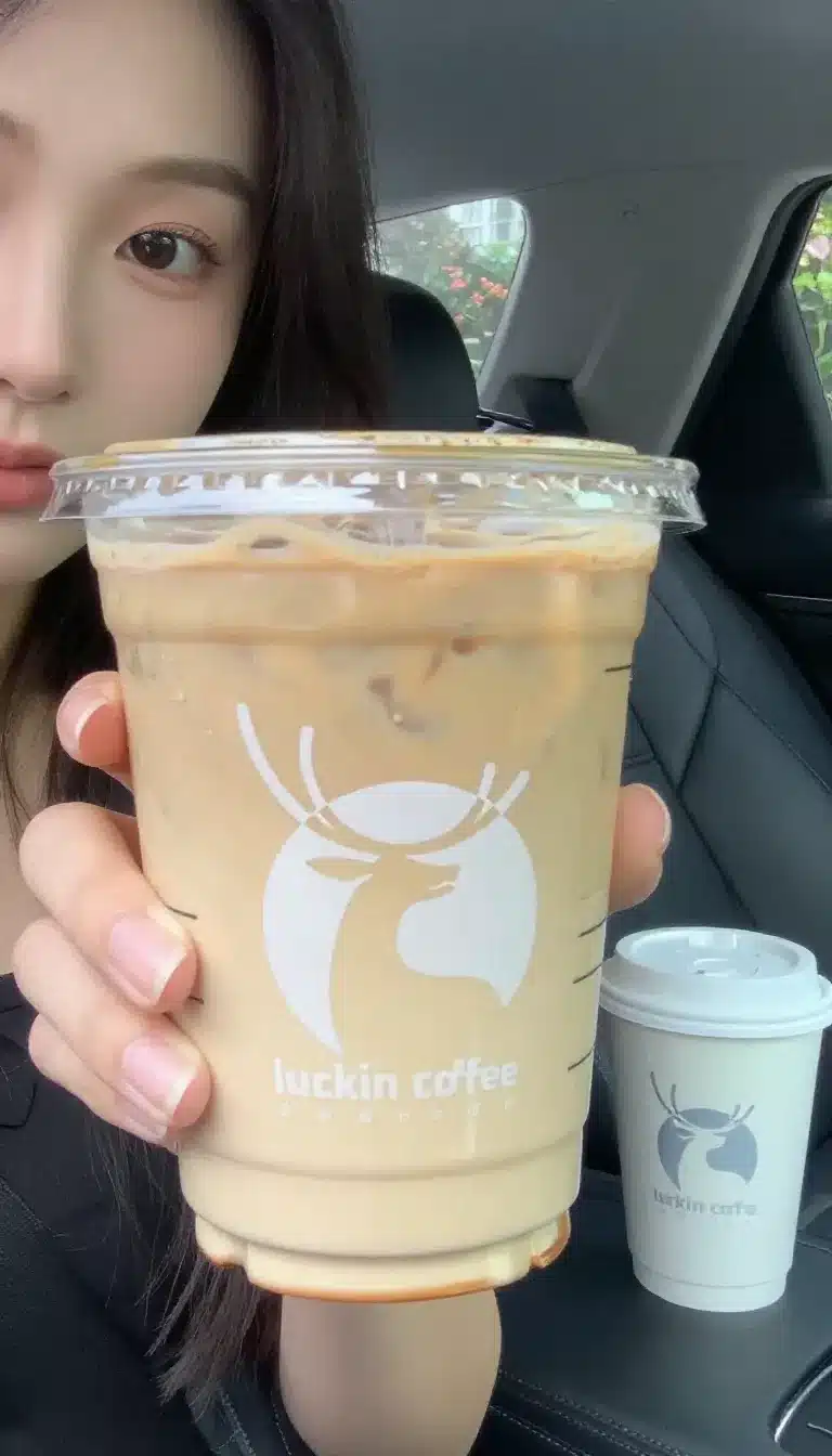 Starbucks Iced Pumpkin Spice Chai Latte 9 A Starbucks iced pumpkin spice chai latte served in a clear cup with ice and a creamy spiced topping.