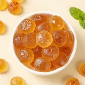 Homemade gelatin dog treats cut into small bite-sized shapes on a kitchen tray, ideal for hiding pills in a dog treat.