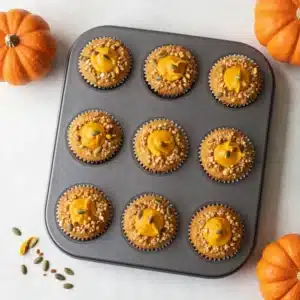 Homemade Starbucks-style pumpkin muffins with a crumb topping on a plate
