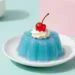 Blue Jelly Cake 4 Blue jelly cake with glossy layers and a smooth decorative finish on a white plate